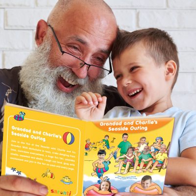 grandad and grandson reading a book featuring themselves and their family