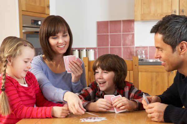 family playing cards at a table