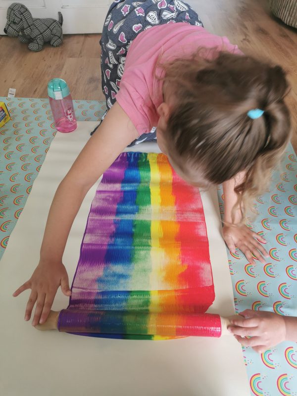 make a rainbow with a rolling pin and paint
