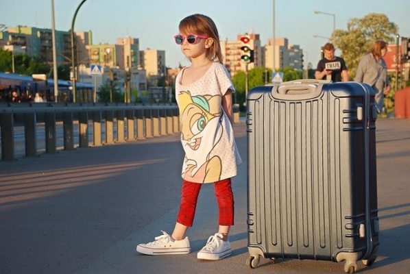 young girl and holiday suitcase