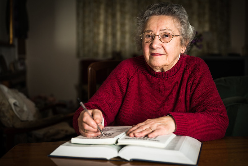 Elderly lady doing a crossword
