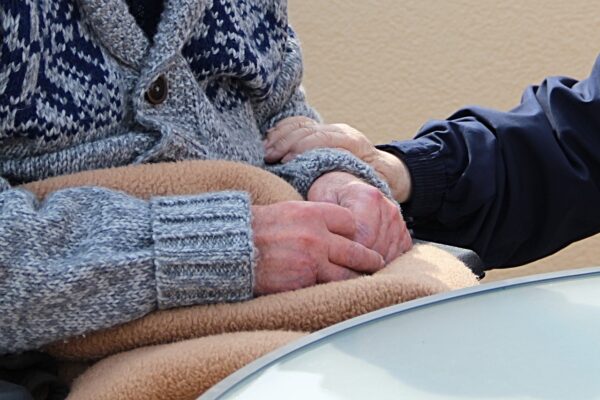 Holding hands of an elderly woman